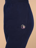 Navy blue pants with a small logo on a beige background